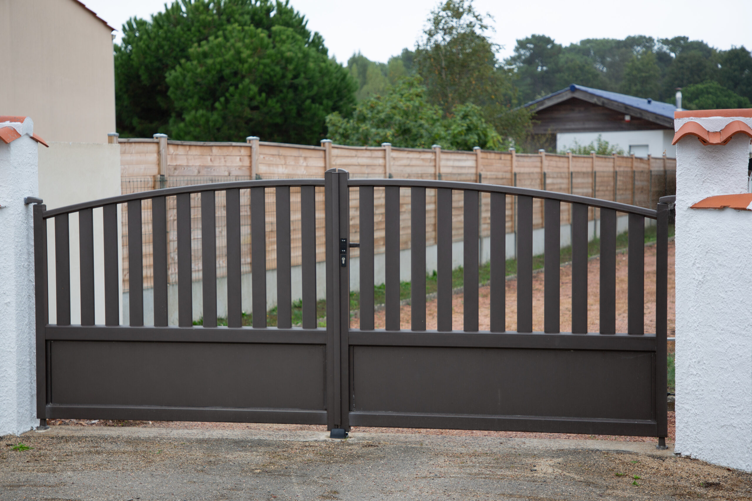 Aluminum dark gray metal double gates to house with portal grey to access home